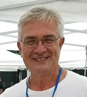 Face of a man smiling at the camera.